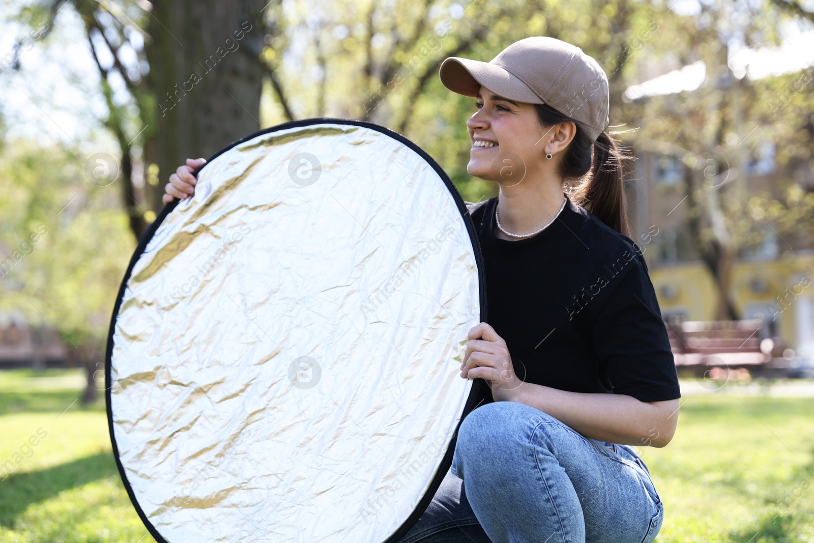Woman with reflector outdoors on sunny day. Photography equipment Photo of Woman with reflector outdoors on sunny day. Photography equipment