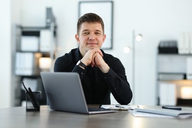 Photo of Portrait of handsome man at desk in office