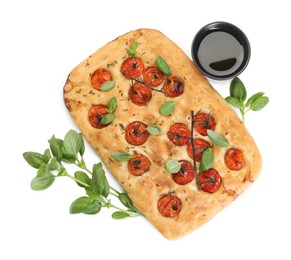 Photo of Delicious focaccia with tomatoes, spices and oil isolated on white, top view