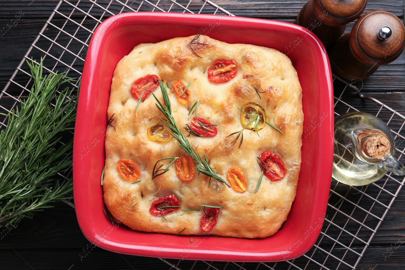 Delicious focaccia with tomatoes, spices and oil on table, flat lay Photo of Delicious focaccia with tomatoes, spices and oil on table, flat lay