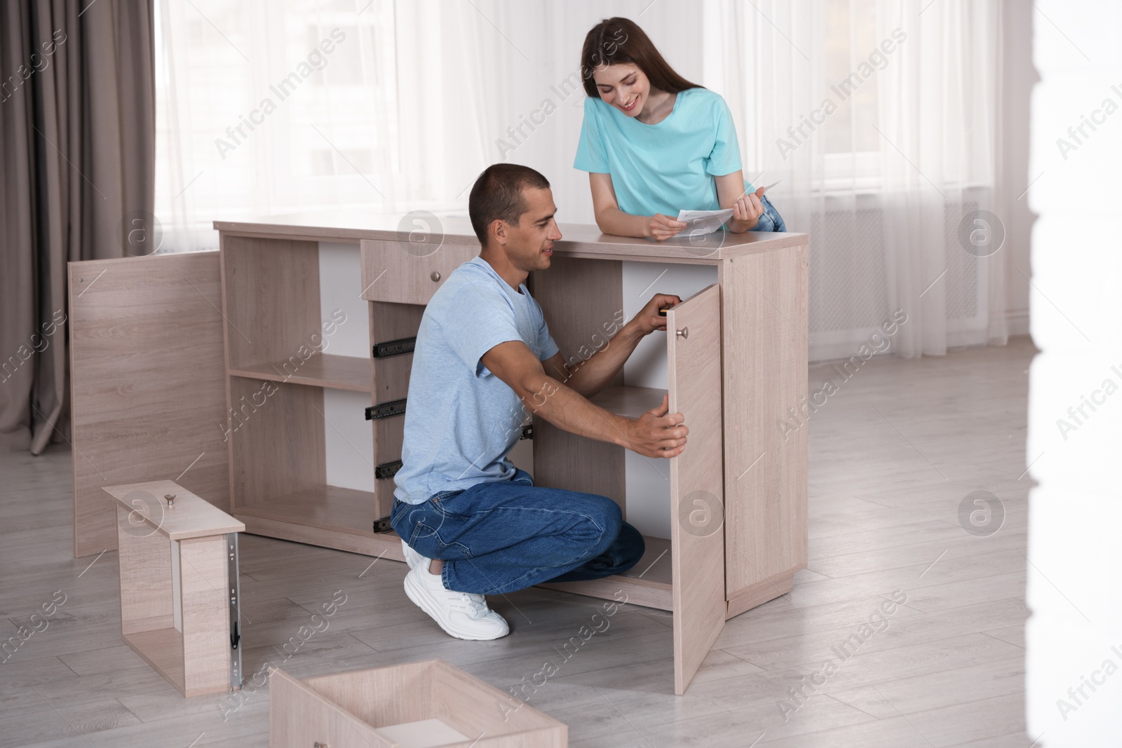 Couple with manual assembling furniture at home Photo of Couple with manual assembling furniture at home