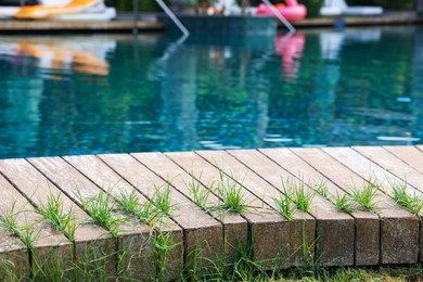 Photo of Outdoor swimming pool with wooden deck at resort