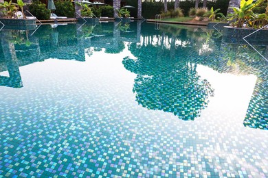 Photo of Outdoor swimming pool with umbrellas and sunbeds at resort