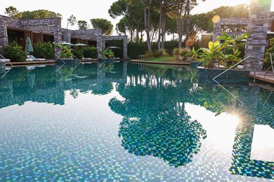 Photo of Outdoor swimming pool with umbrellas and sunbeds at resort