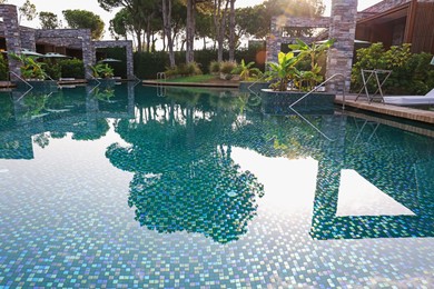 Photo of Outdoor swimming pool with umbrellas and sunbeds at resort