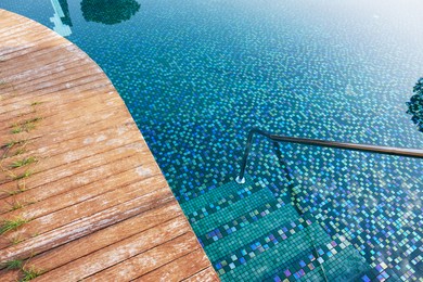 Photo of Outdoor swimming pool with steps and rail at resort
