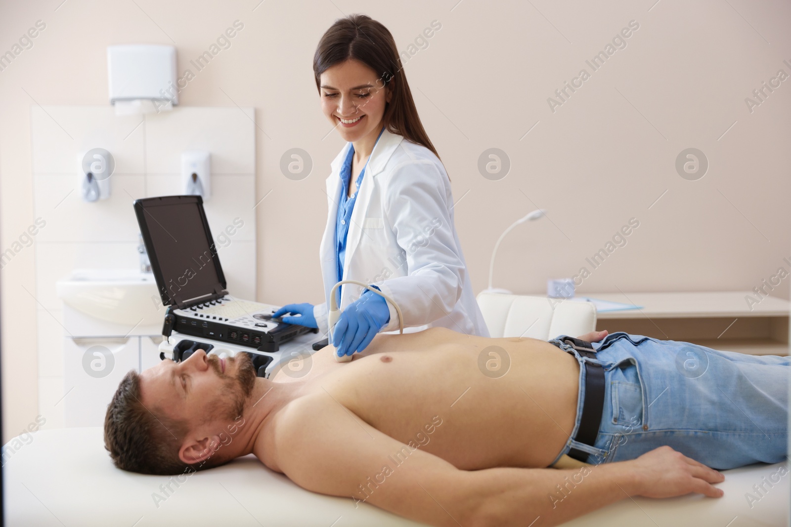 Sonographer conducting ultrasound examination of man's heart in clinic Photo of Sonographer conducting ultrasound examination of man's heart in clinic