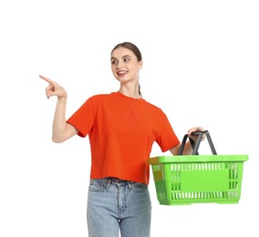 Photo of Woman with plastic shopping basket pointing at something on white background