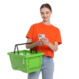 Photo of Woman with plastic shopping basket and smartphone on white background
