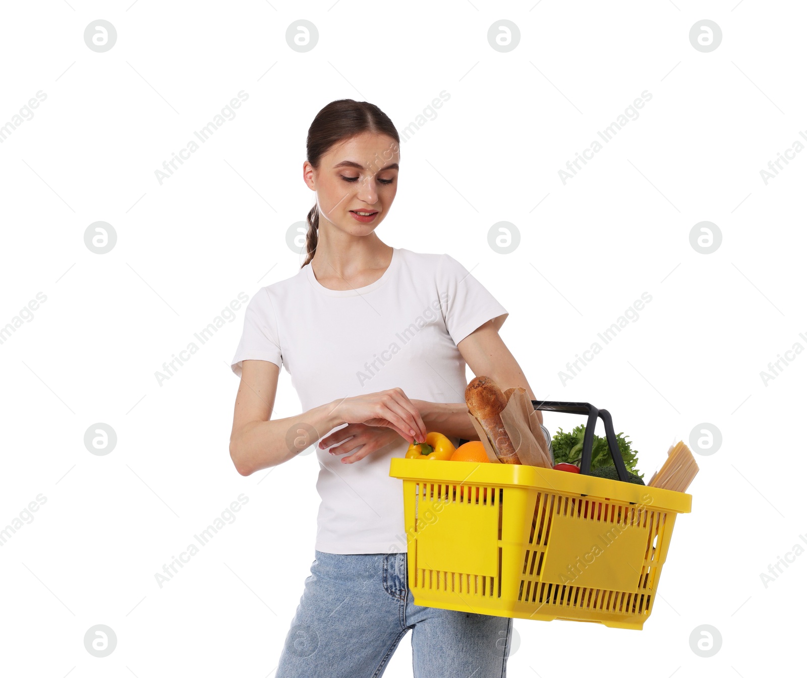 Woman with shopping basket full of products on white background Photo of Woman with shopping basket full of products on white background