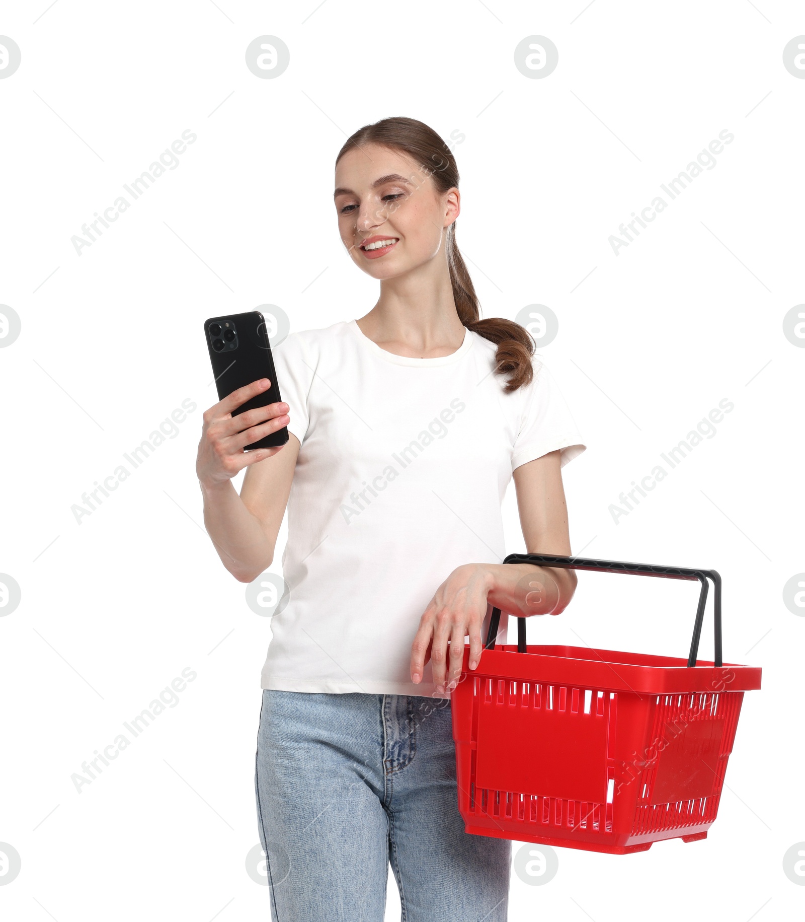 Photo of Woman with plastic shopping basket and smartphone on white background