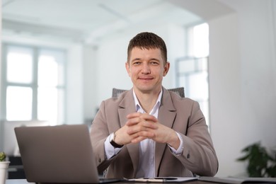 Photo of Portrait of handsome man at desk in office