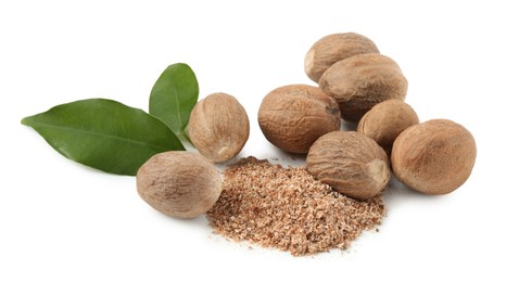 Photo of Whole nutmegs, powder and leaves isolated on white
