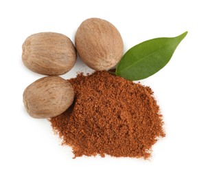 Photo of Whole nutmegs, powder and leaf isolated on white, top view