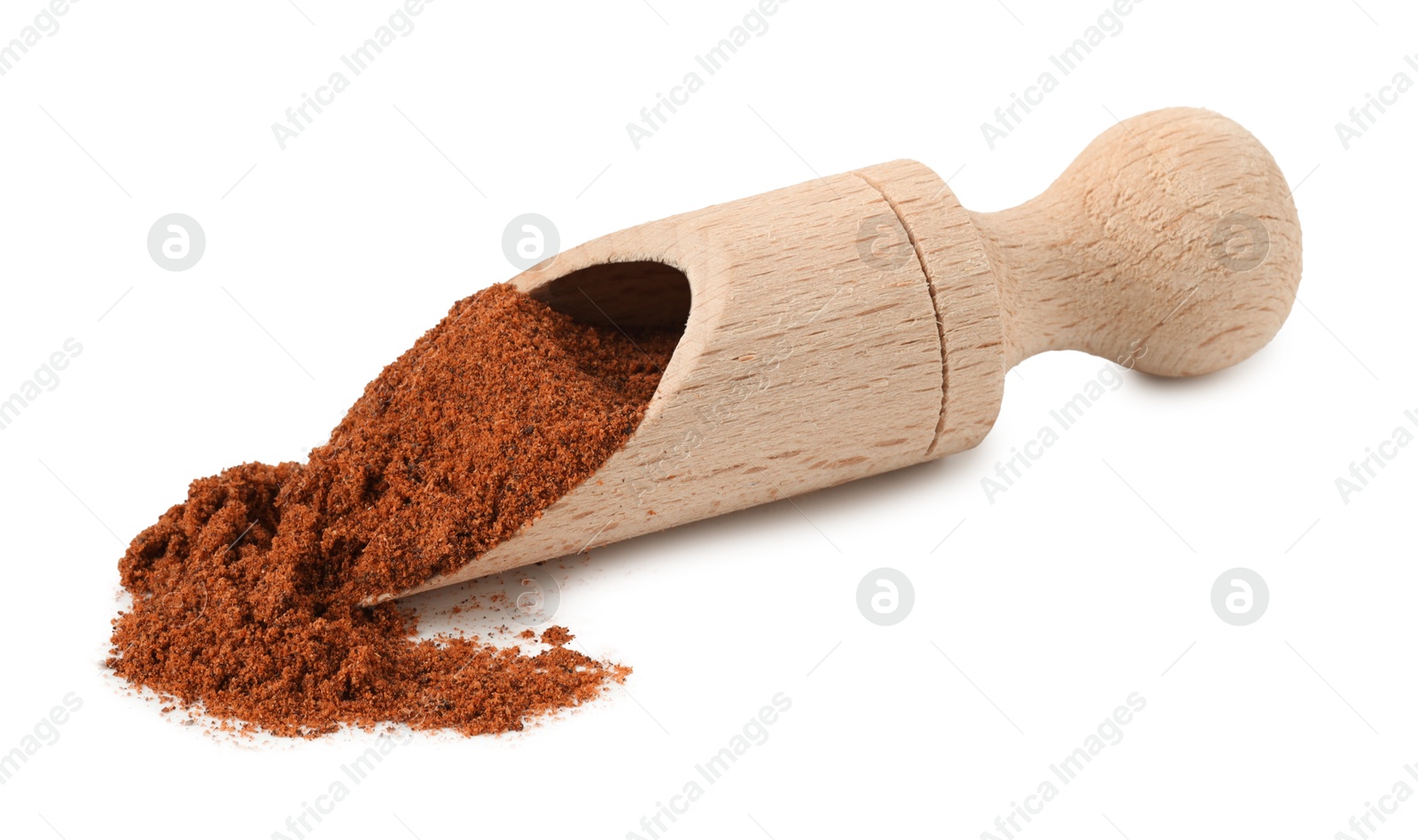 Nutmeg powder in scoop isolated on white Photo of Nutmeg powder in scoop isolated on white