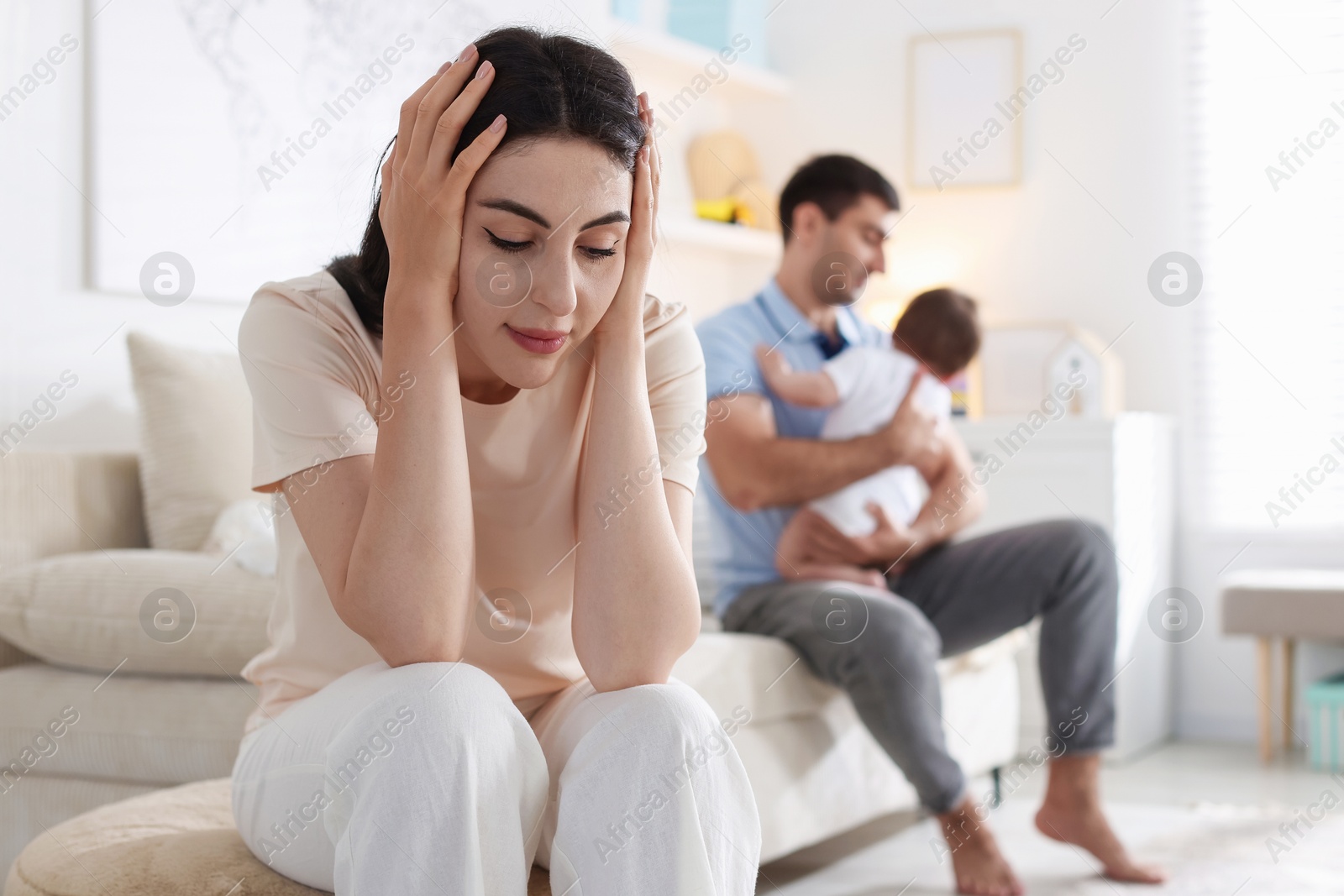 Woman suffering from postpartum depression and her husband with baby at home, selective focus Photo of Woman suffering from postpartum depression and her husband with baby at home, selective focus