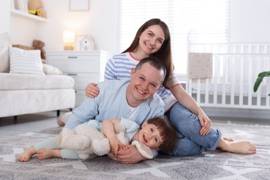 Photo of Cute little boy and his parents at home. Lovely family