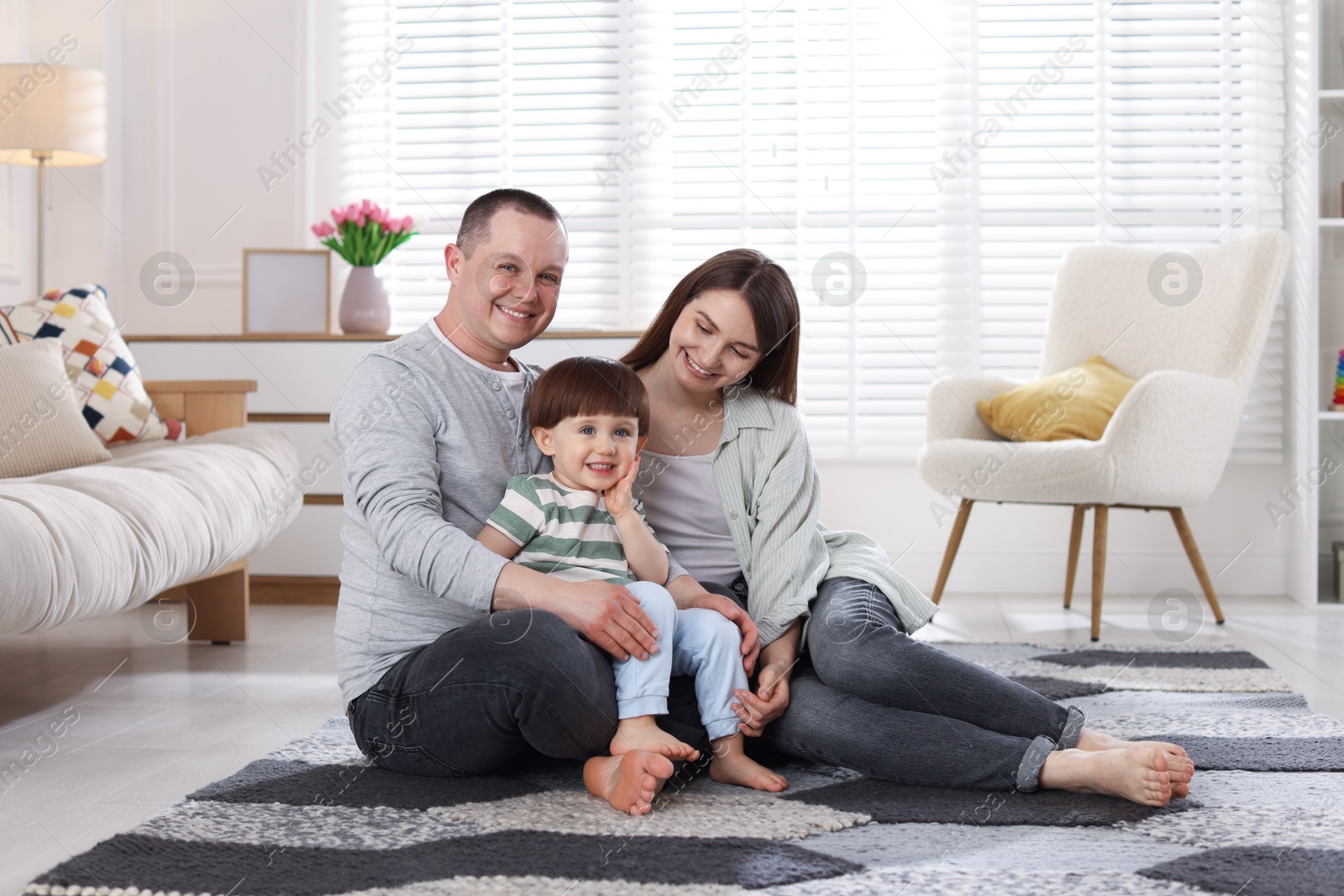 Cute little boy and his parents at home. Lovely family Photo of Cute little boy and his parents at home. Lovely family