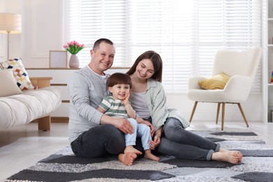 Photo of Cute little boy and his parents at home. Lovely family