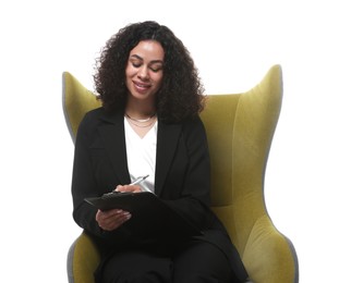 Photo of Professional psychologist with clipboard and pen in armchair on white background