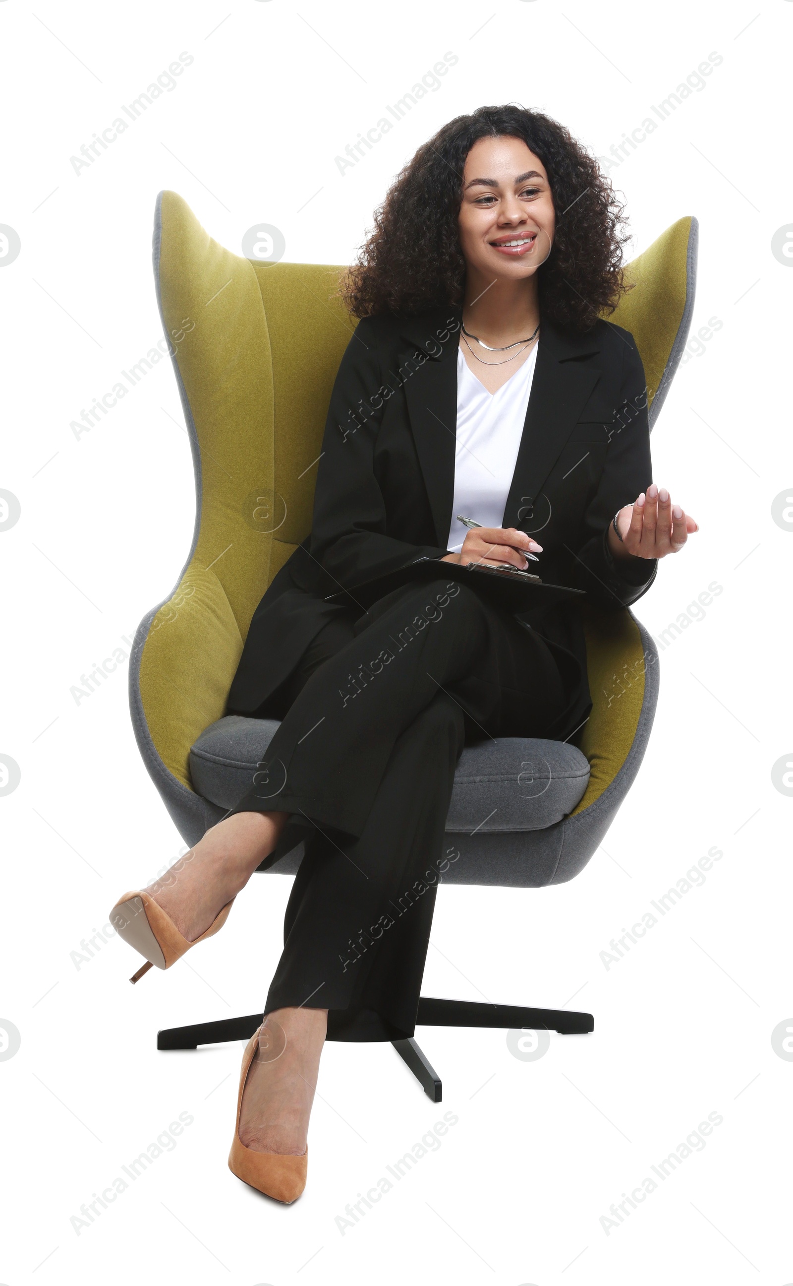 Professional psychologist with clipboard and pen in armchair on white background Photo of Professional psychologist with clipboard and pen in armchair on white background