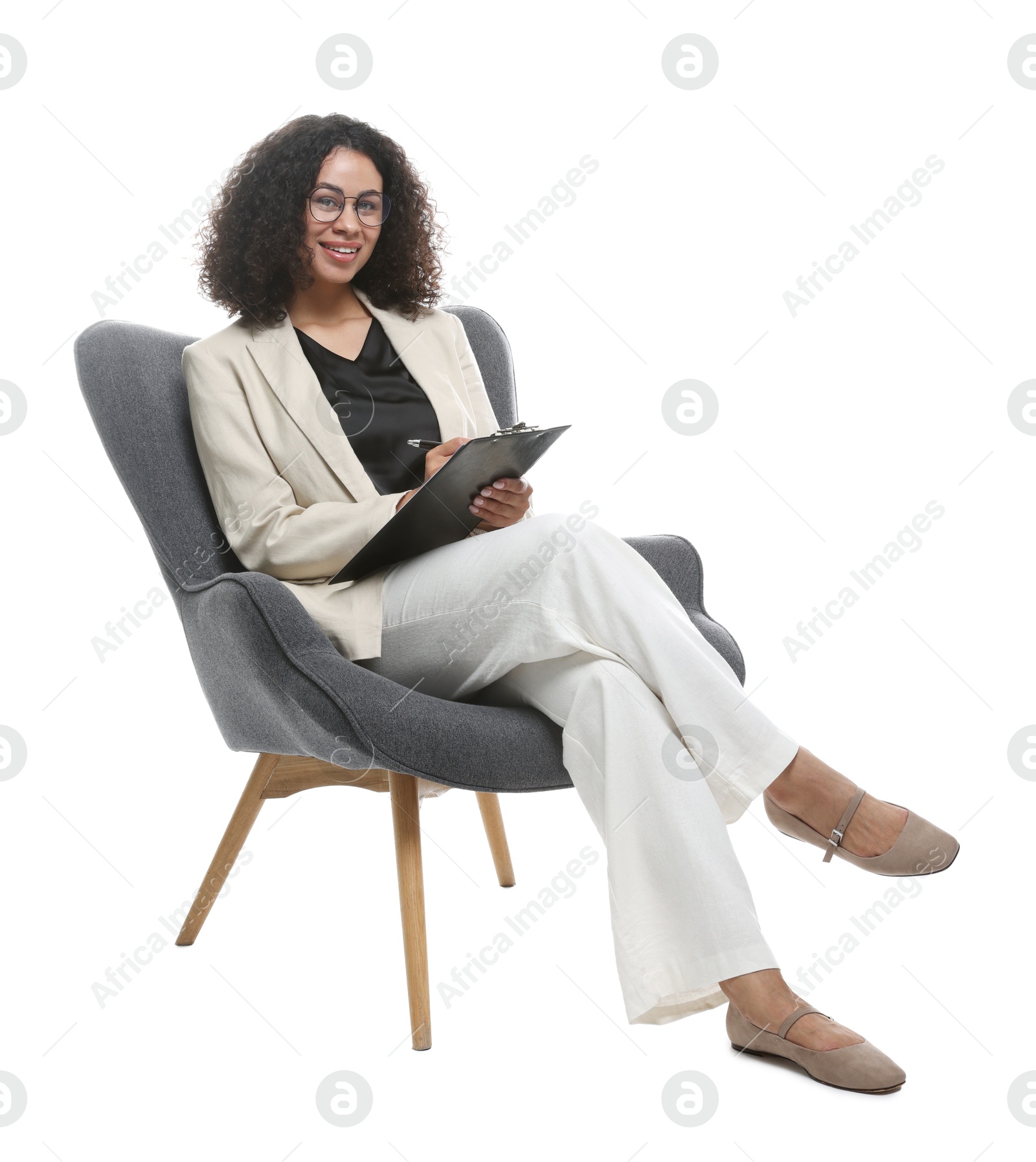 Professional psychologist with clipboard and pen in armchair on white background Photo of Professional psychologist with clipboard and pen in armchair on white background