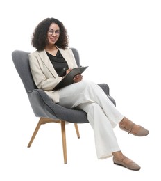 Photo of Professional psychologist with clipboard and pen in armchair on white background