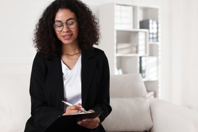 Photo of Professional psychologist taking notes in office, space for text