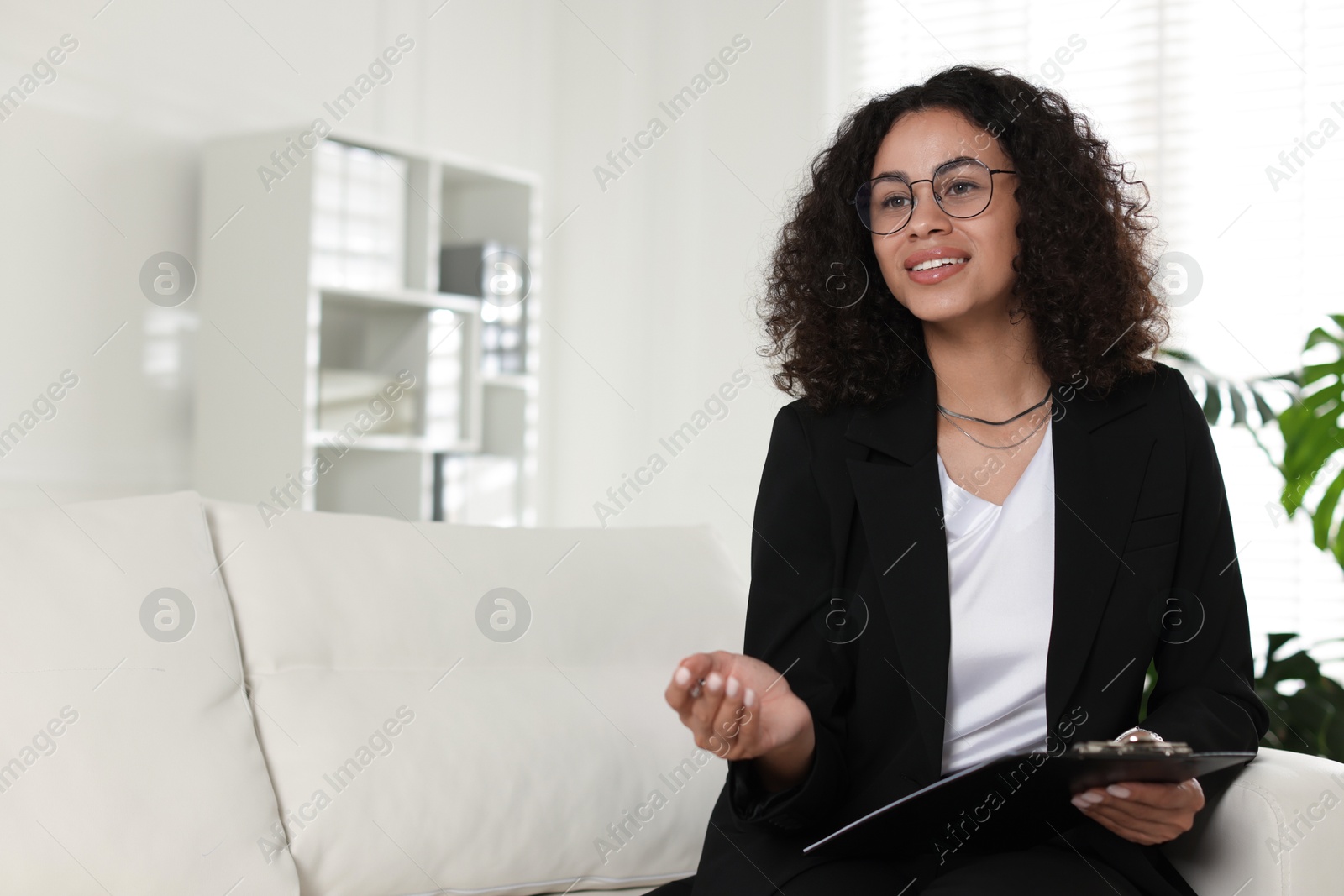 Professional psychologist with clipboard and pen in office, space for text Photo of Professional psychologist with clipboard and pen in office, space for text