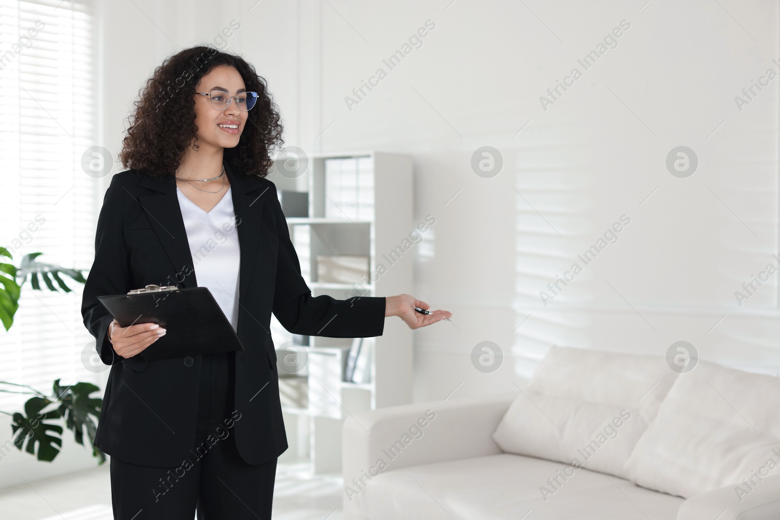Professional psychologist with clipboard and pen in office, space for text Photo of Professional psychologist with clipboard and pen in office, space for text