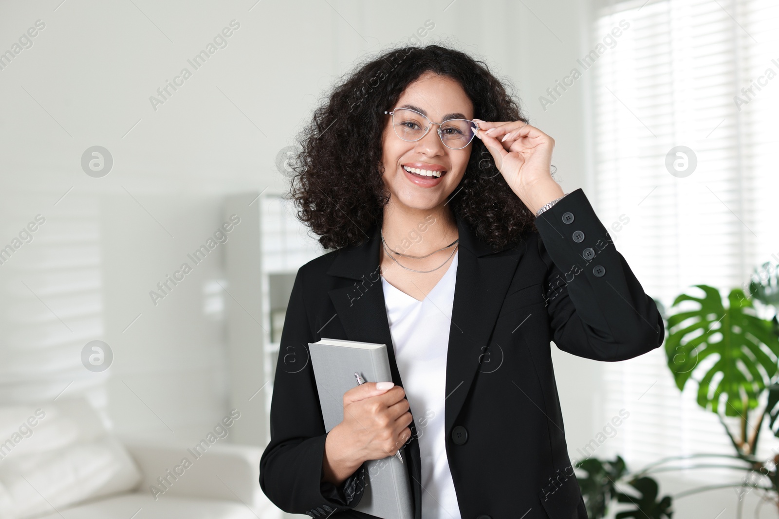 Professional psychologist with notebook and pen in office Photo of Professional psychologist with notebook and pen in office