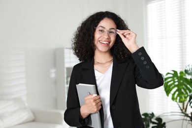 Photo of Professional psychologist with notebook and pen in office