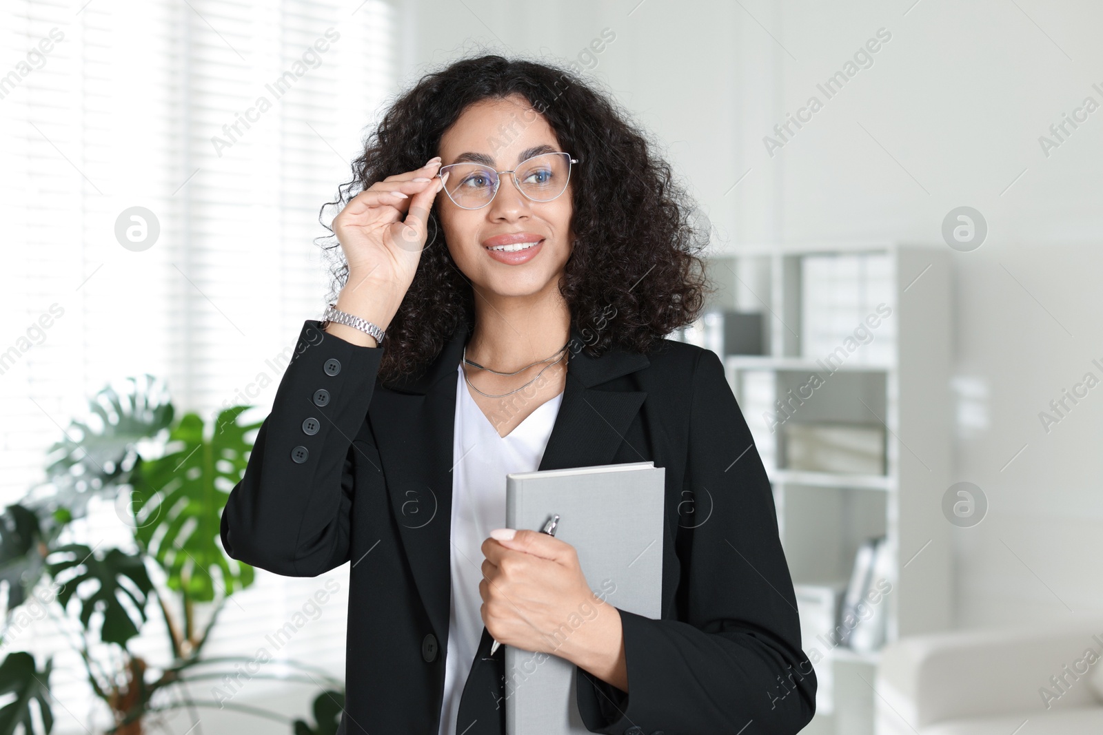 Professional psychologist with notebook and pen in office Photo of Professional psychologist with notebook and pen in office