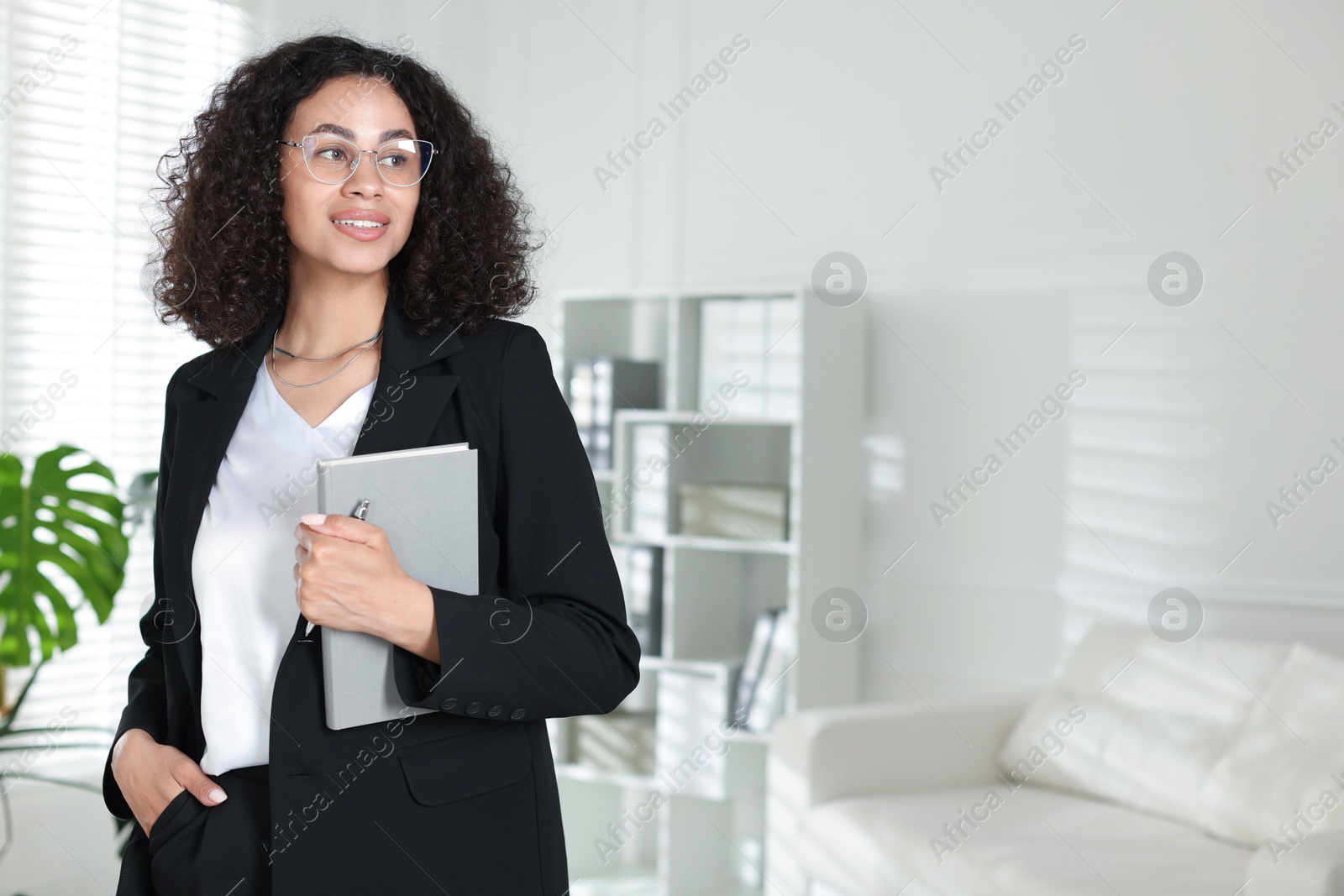 Professional psychologist with notebook and pen in office, space for text Photo of Professional psychologist with notebook and pen in office, space for text