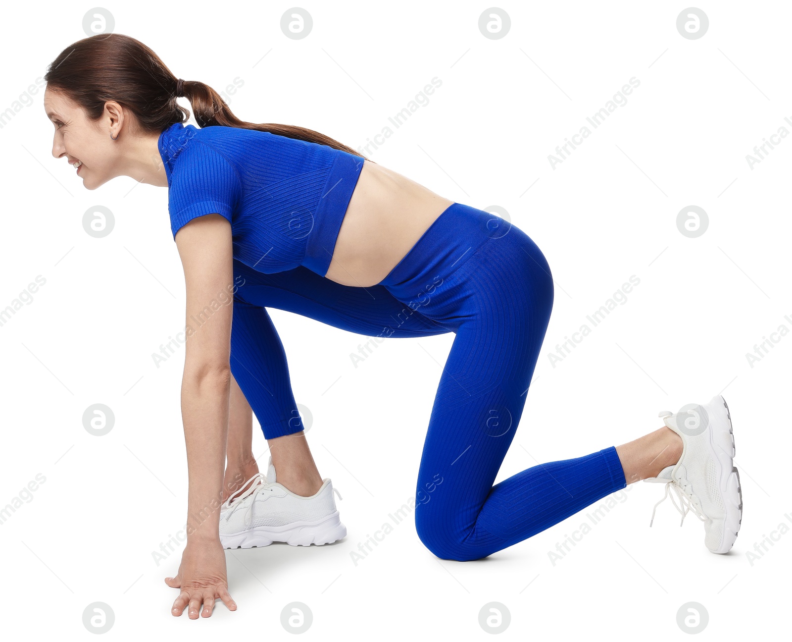 Runner in starting position on white background Photo of Runner in starting position on white background