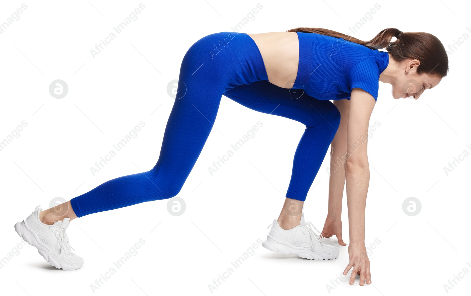 Runner in starting position on white background Photo of Runner in starting position on white background
