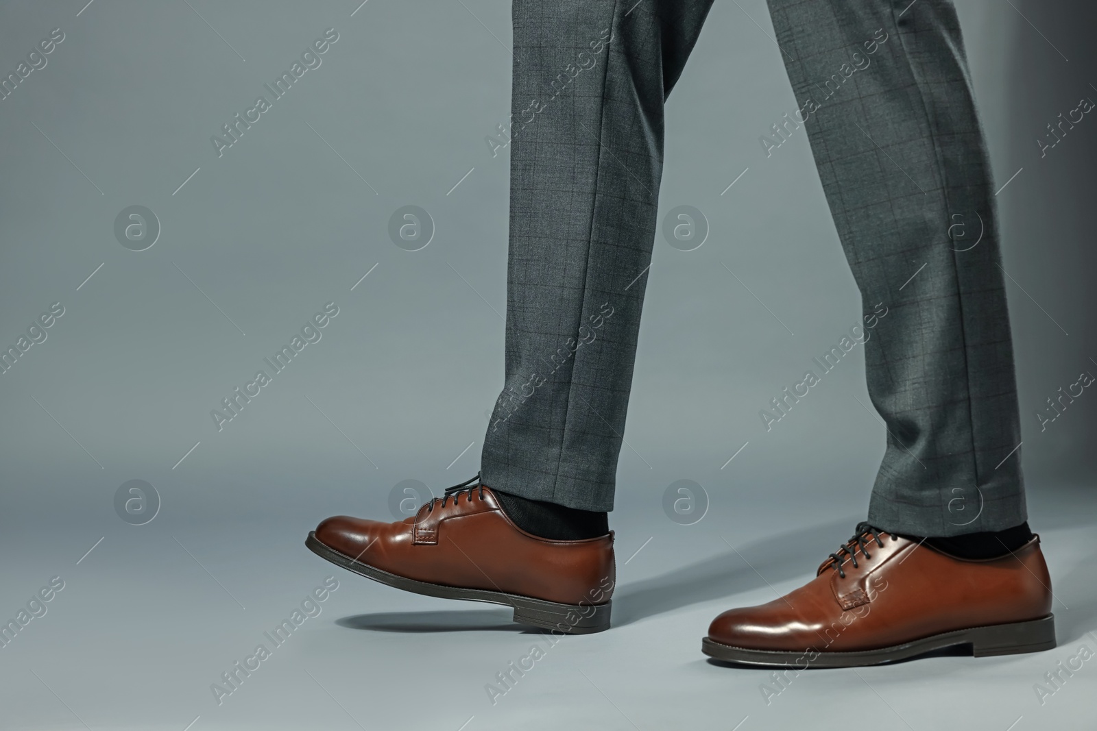 Businessman in starting position on gray background, closeup. Space for text Photo of Businessman in starting position on gray background, closeup. Space for text