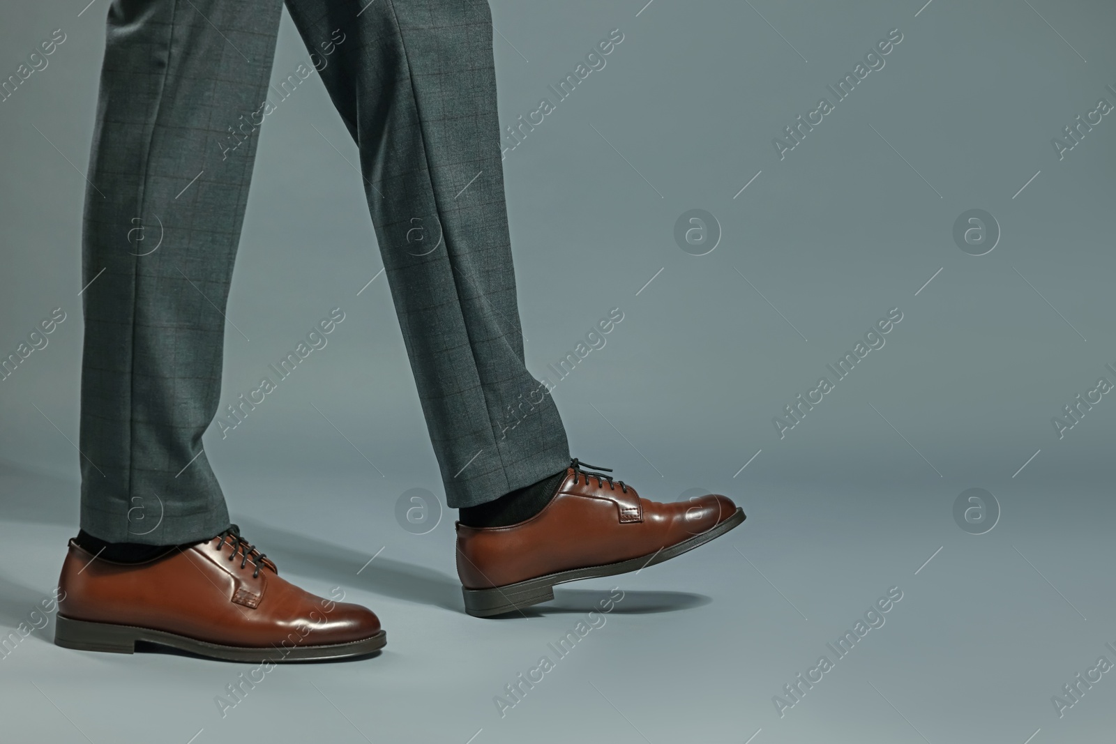 Businessman in starting position on gray background, closeup. Space for text Photo of Businessman in starting position on gray background, closeup. Space for text