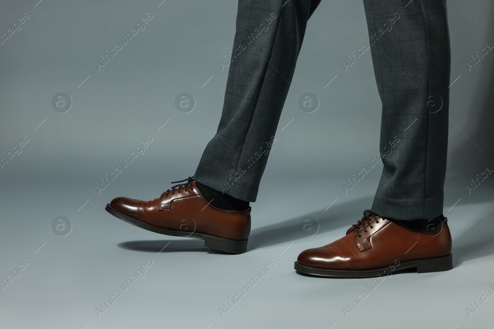 Businessman in starting position on gray background, closeup Photo of Businessman in starting position on gray background, closeup