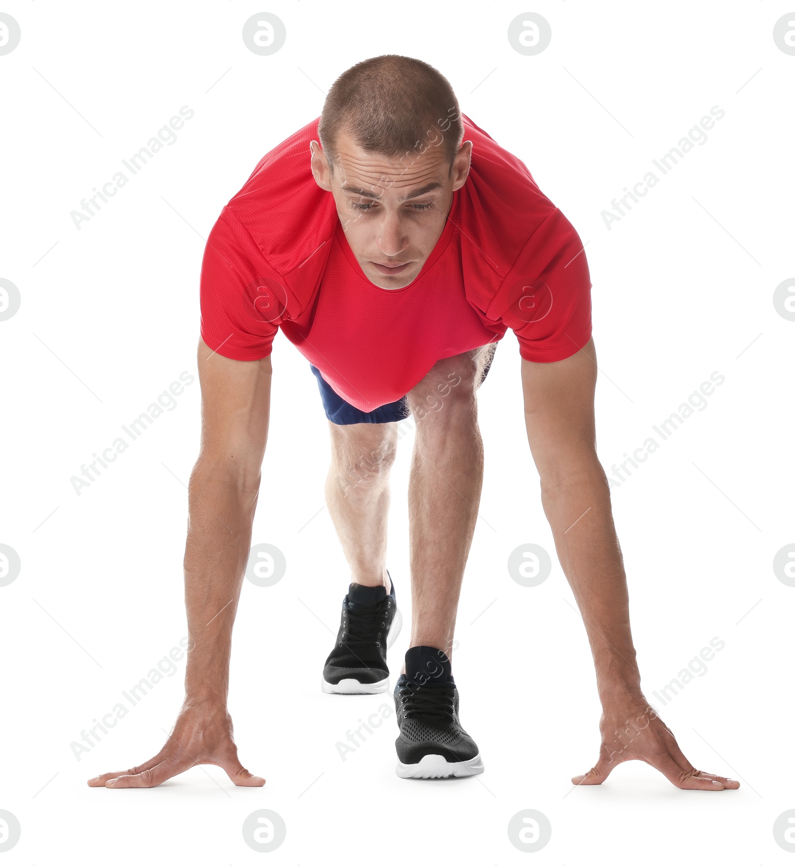 Runner in starting position on white background Photo of Runner in starting position on white background