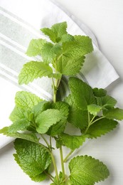 Photo of Fresh lemon balm leaves on white table, top view