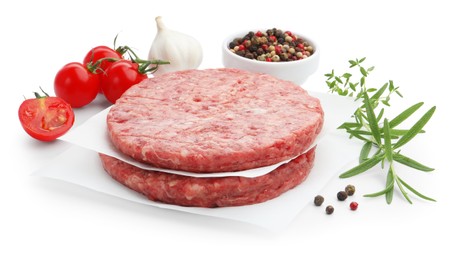 Photo of Fresh raw patties for burger, tomatoes and spices isolated on white