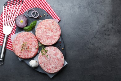 Photo of Fresh raw patties for burger and spices on grey table, flat lay. Space for text