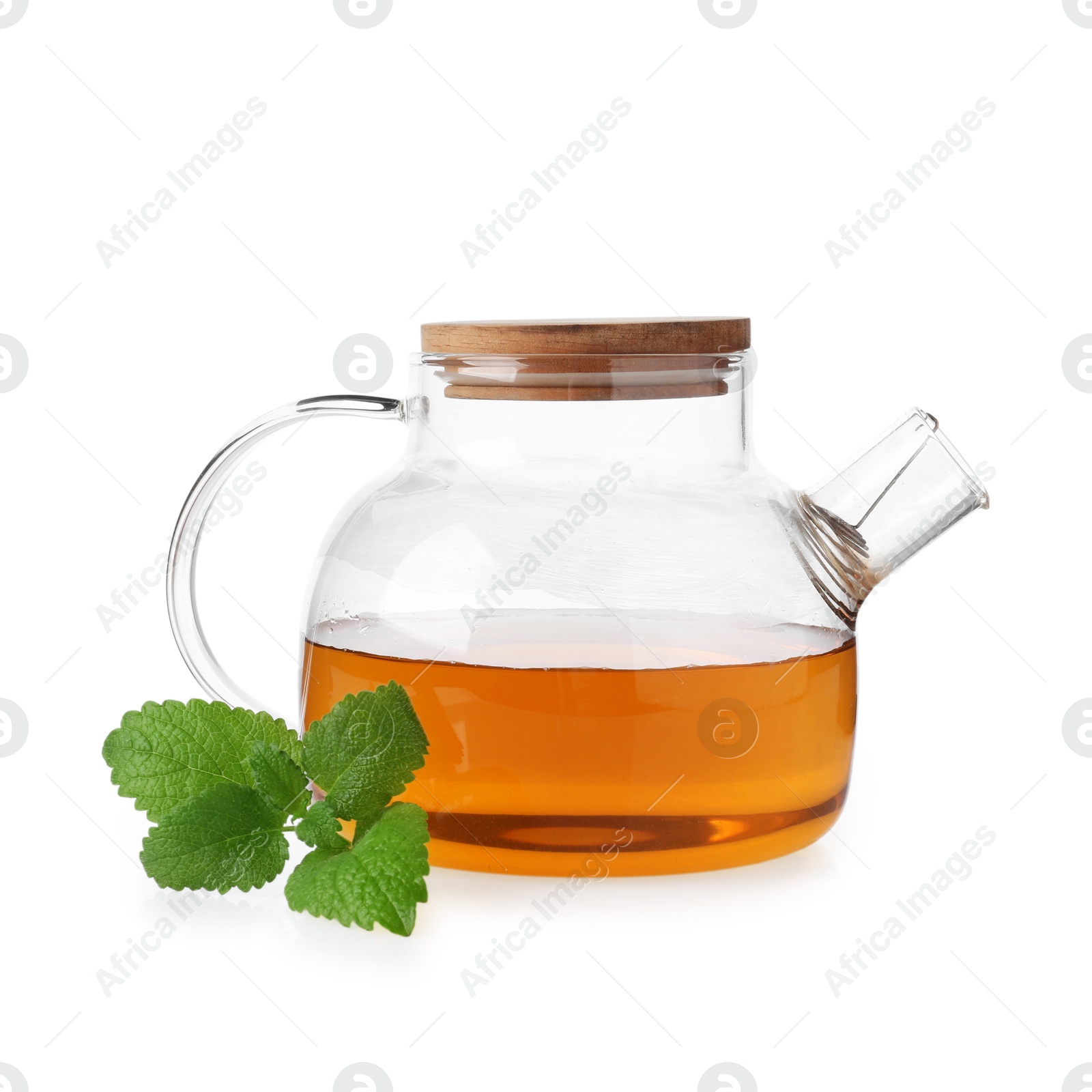 Aromatic lemon balm tea in glass teapot and fresh leaves isolated on white Photo of Aromatic lemon balm tea in glass teapot and fresh leaves isolated on white