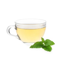 Photo of Aromatic lemon balm tea in glass cup and fresh leaves isolated on white
