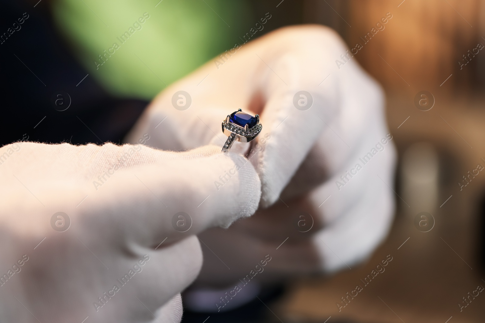 Appraiser working with luxury ring indoors, closeup Photo of Appraiser working with luxury ring indoors, closeup