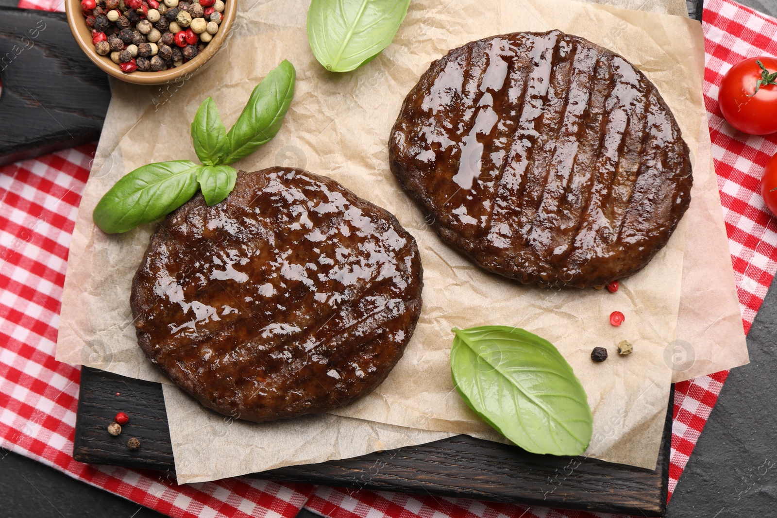 Delicious hamburger patties and spices on black table, top view Photo of Delicious hamburger patties and spices on black table, top view