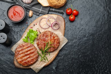 Photo of Delicious hamburger patties, tomatoes and spices on black table, flat lay
