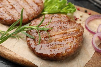 Photo of Delicious hamburger patties and spices on table, closeup