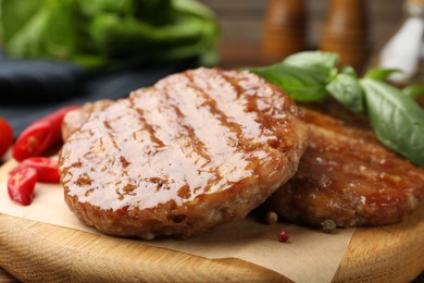 Photo of Delicious hamburger patties and spices on table, closeup